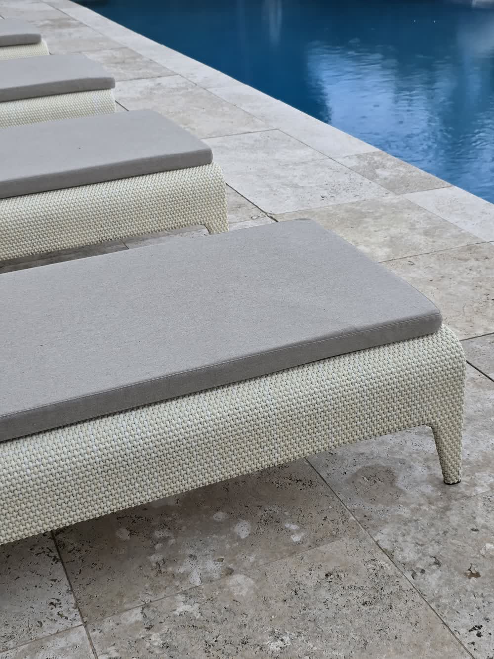 Cream poolside pavers with loungers